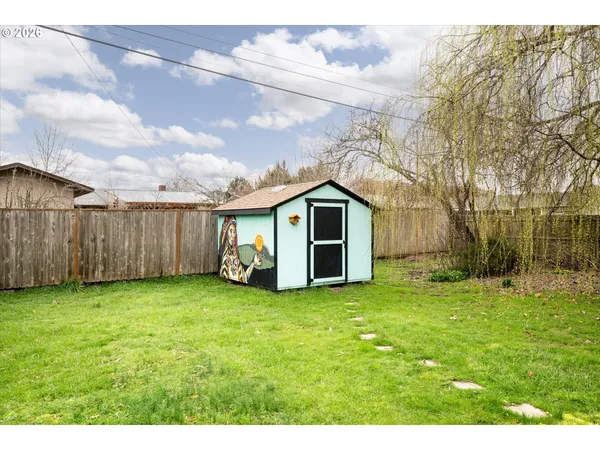 a view of a backyard with plants and a patio