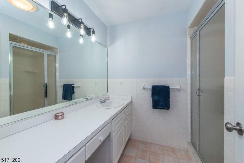 106 Fieldcrest Road Parsippany, NJ 07054 - Photo 15 of 18 a bathroom with a double vanity sink and mirror