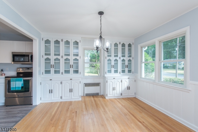 106 Fieldcrest Road Parsippany, NJ 07054 - Photo 6 of 18 a view of empty room with wooden floor and fan