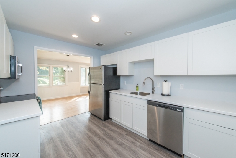 106 Fieldcrest Road Parsippany, NJ 07054 - Photo 7 of 18 a kitchen with a refrigerator and a sink