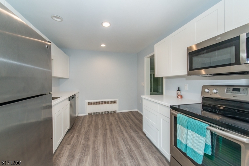 106 Fieldcrest Road Parsippany, NJ 07054 - Photo 9 of 18 a kitchen with a sink and a stove top oven
