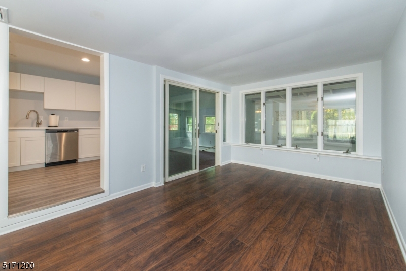 106 Fieldcrest Road Parsippany, NJ 07054 - Photo 10 of 18 an empty room with wooden floor and windows