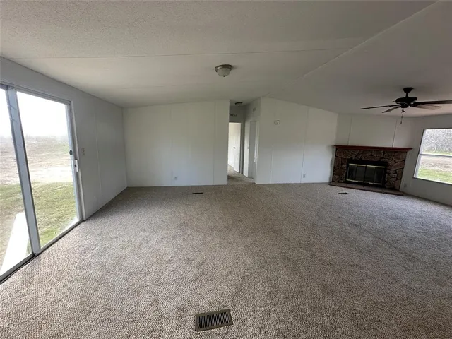 a kitchen with a sink a microwave a refrigerator and cabinets