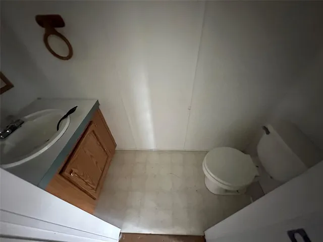 a view of an empty room and wooden floor