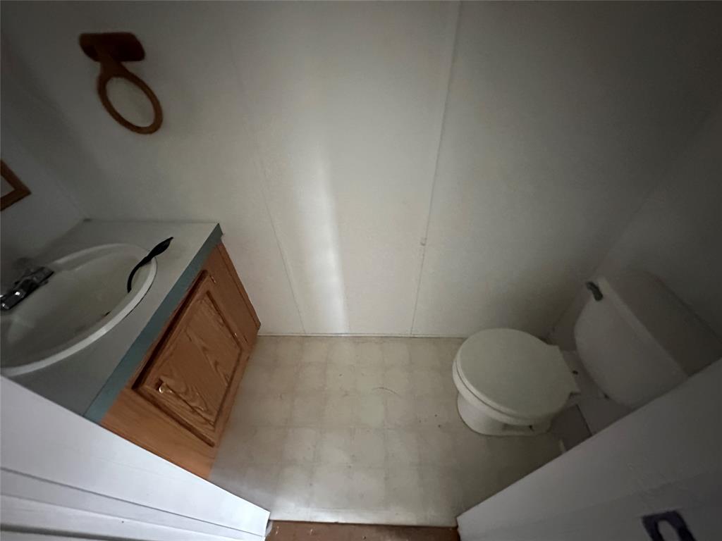 230 Largo Street Bonham, TX 75418 - Photo 22 of 34 a bathroom with a toilet and a sink