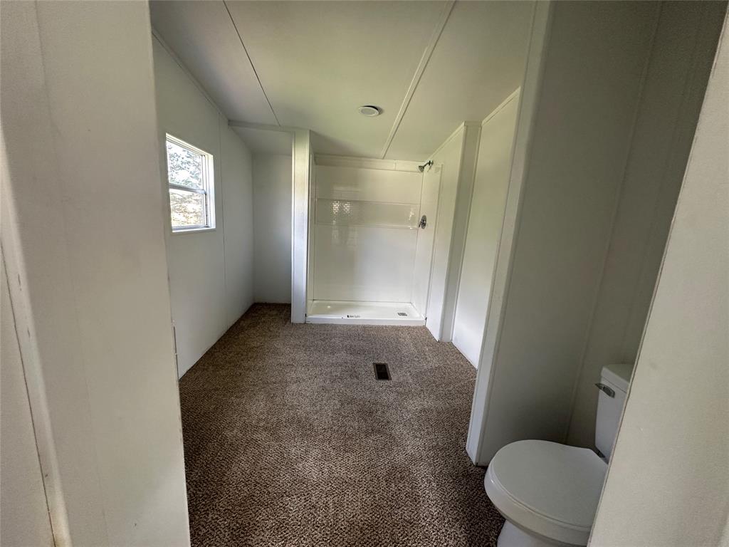 230 Largo Street Bonham, TX 75418 - Photo 26 of 34 a bathroom with a toilet and a shower