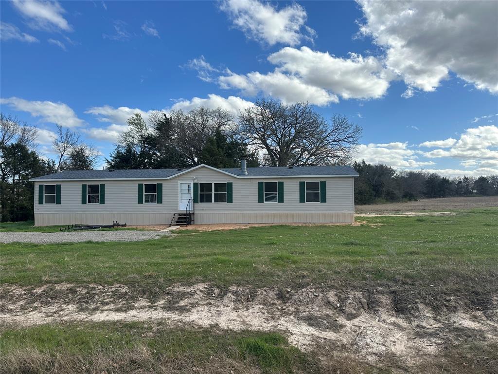 230 Largo Street Bonham, TX 75418 - Photo 33 of 34 a view of a yard in front of a house with a large tree