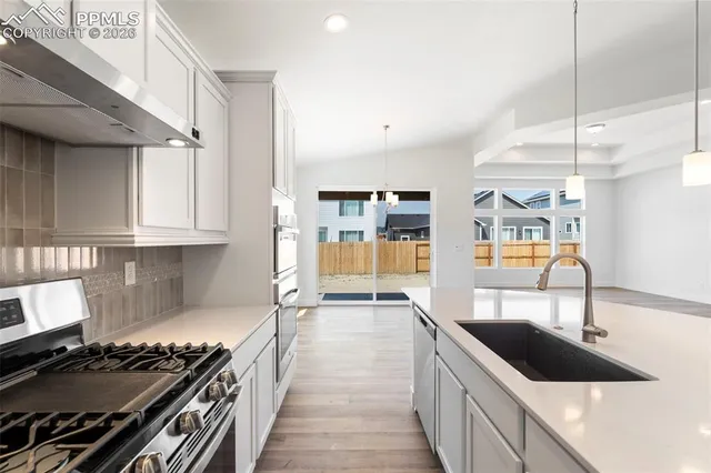 a kitchen with a stove and a sink