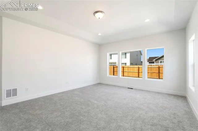 an empty room with windows and closet