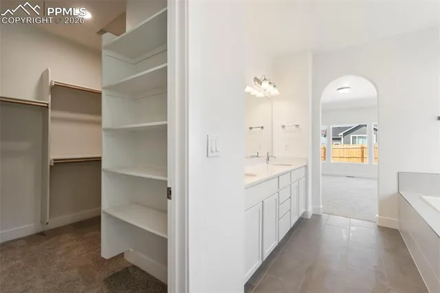 a spacious bathroom with a double vanity sink mirror and shower