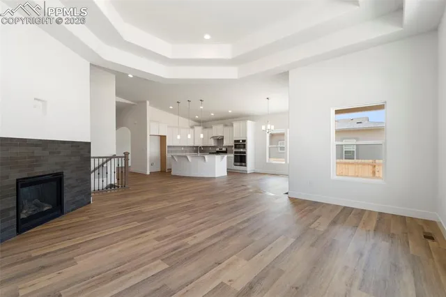 a view of kitchen with livingroom and wooden floor