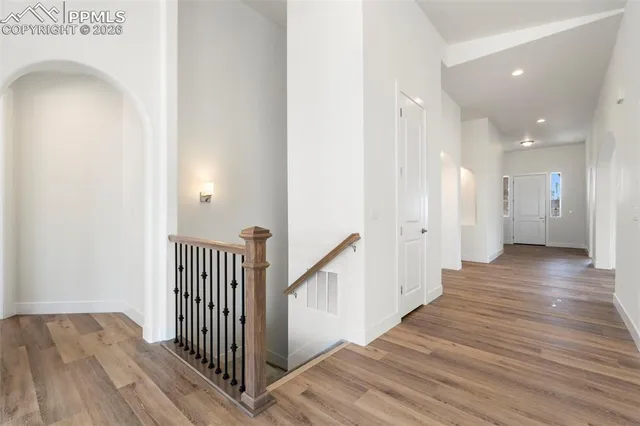 a view of a hallway with wooden floor