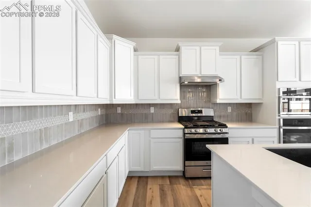 a kitchen with a white cabinets and white appliances