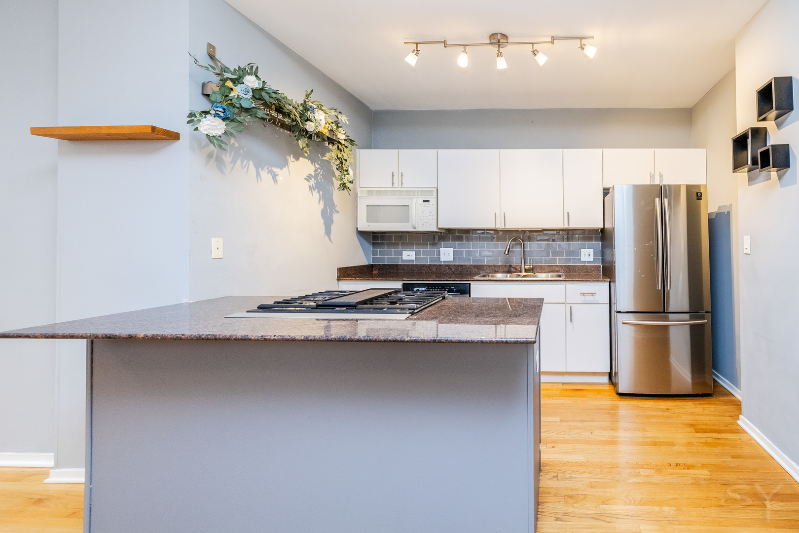 811 South Lytle Street, Unit 213 Chicago, IL 60607 - Photo 11 of 21 a kitchen with stainless steel appliances granite countertop a refrigerator a sink dishwasher a stove and white countertops with wooden floor