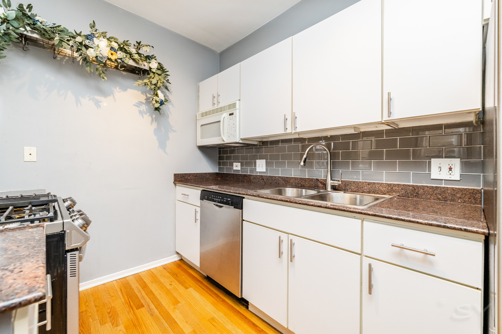 811 South Lytle Street, Unit 213 Chicago, IL 60607 - Photo 12 of 21 a kitchen with stainless steel appliances granite countertop a sink a stove and cabinets