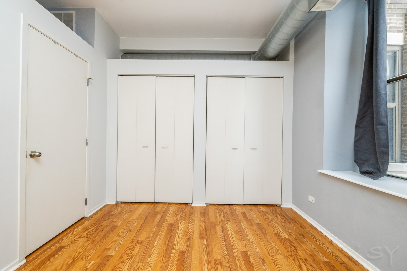 811 South Lytle Street, Unit 213 Chicago, IL 60607 - Photo 14 of 21 a view of a room with a wooden floor and a window