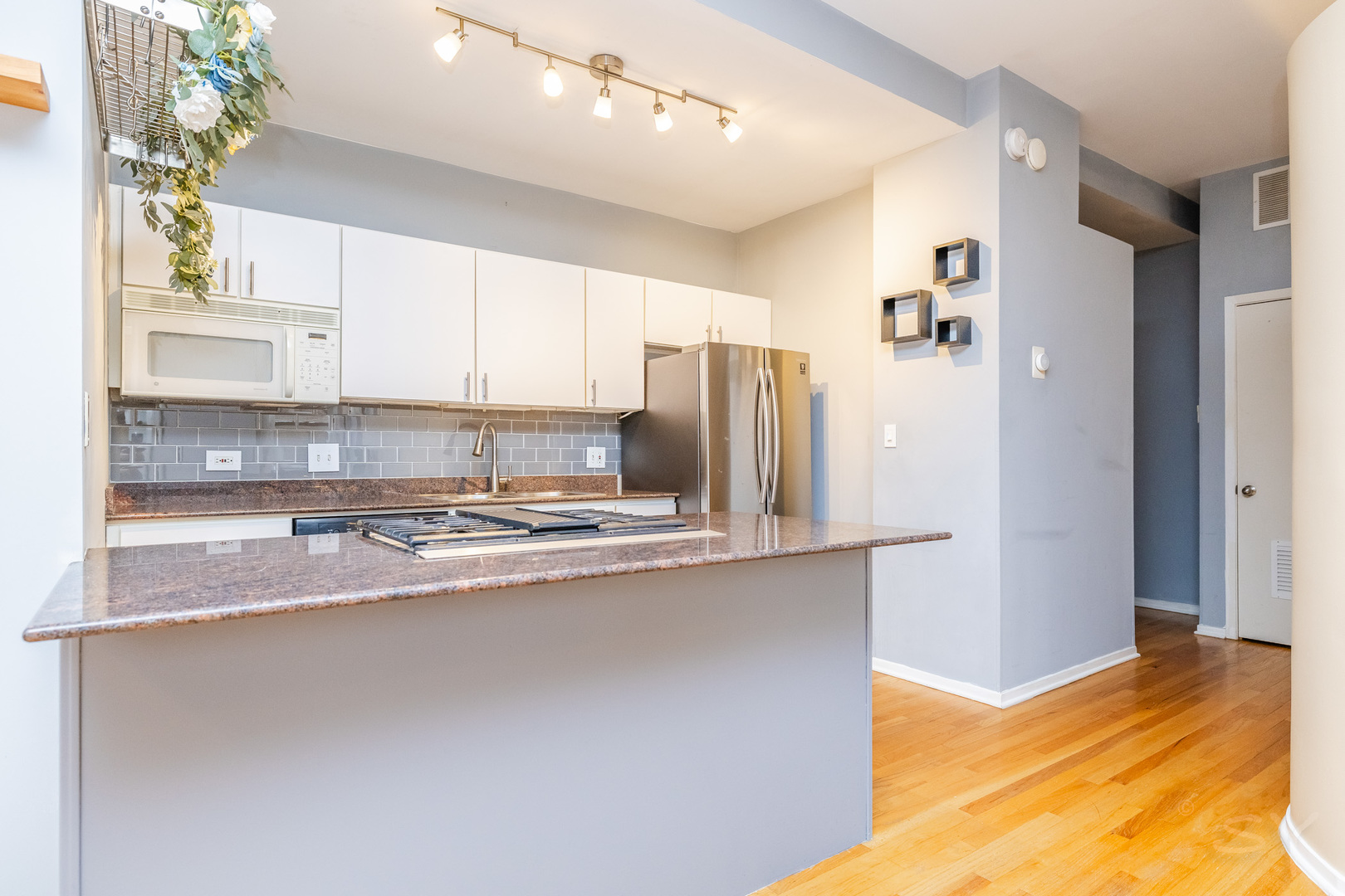 811 South Lytle Street, Unit 213 Chicago, IL 60607 - Photo 10 of 21 a kitchen with stainless steel appliances granite countertop a refrigerator a sink and a stove