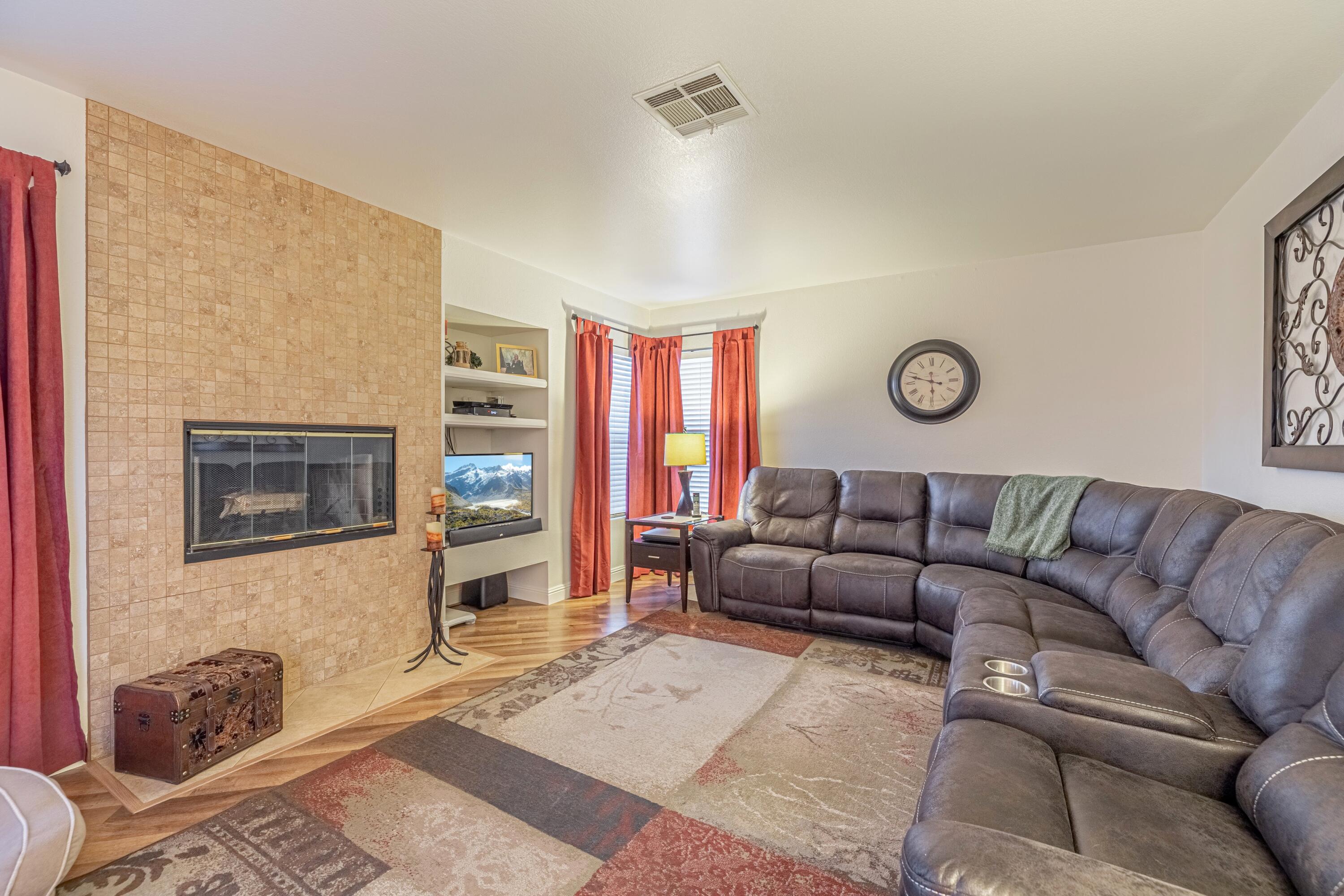 44220 Encanto Way Lancaster, CA 93536 - Photo 13 of 45 a living room with furniture a flat screen tv and a fireplace