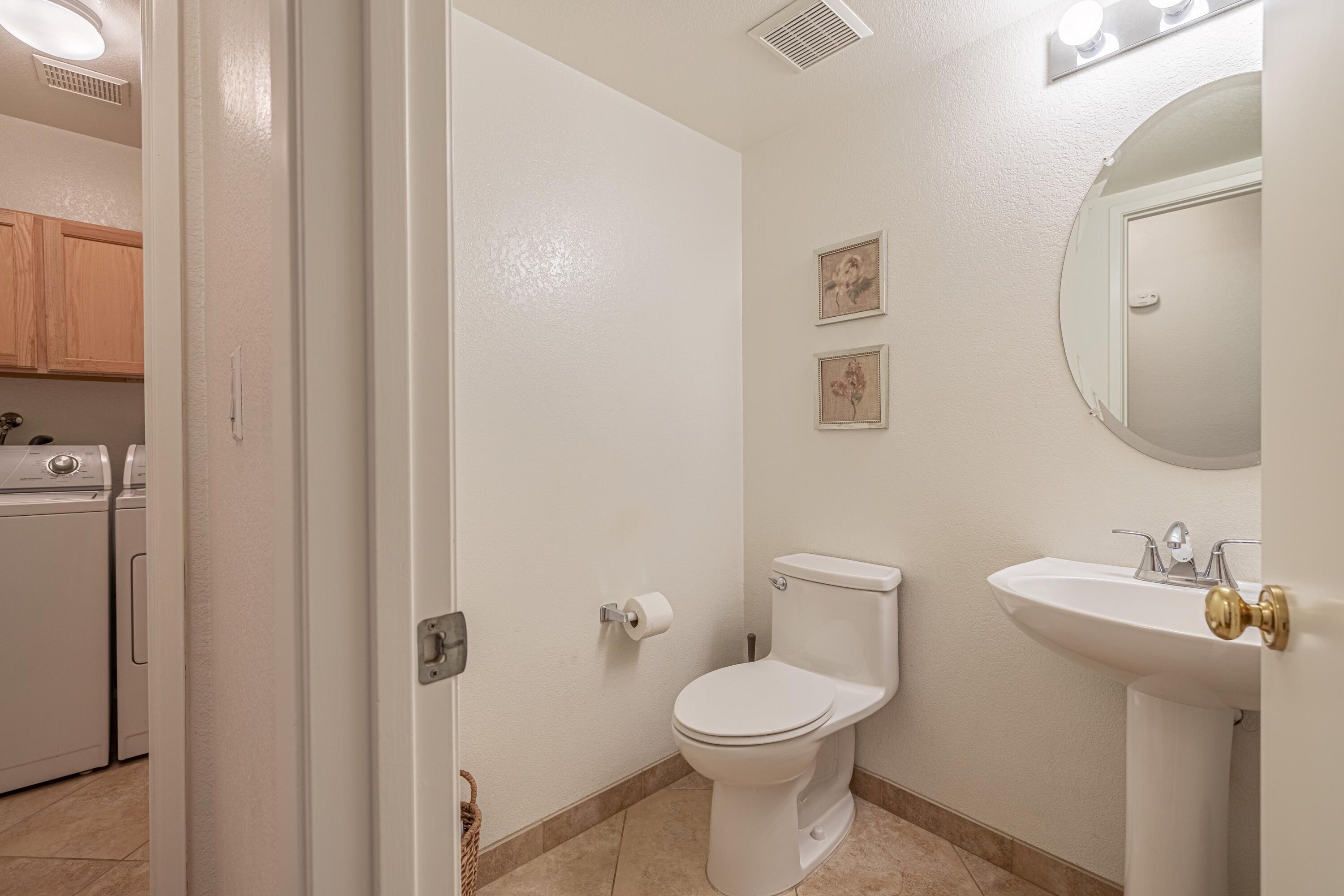 44220 Encanto Way Lancaster, CA 93536 - Photo 15 of 45 a bathroom with a toilet a sink and mirror