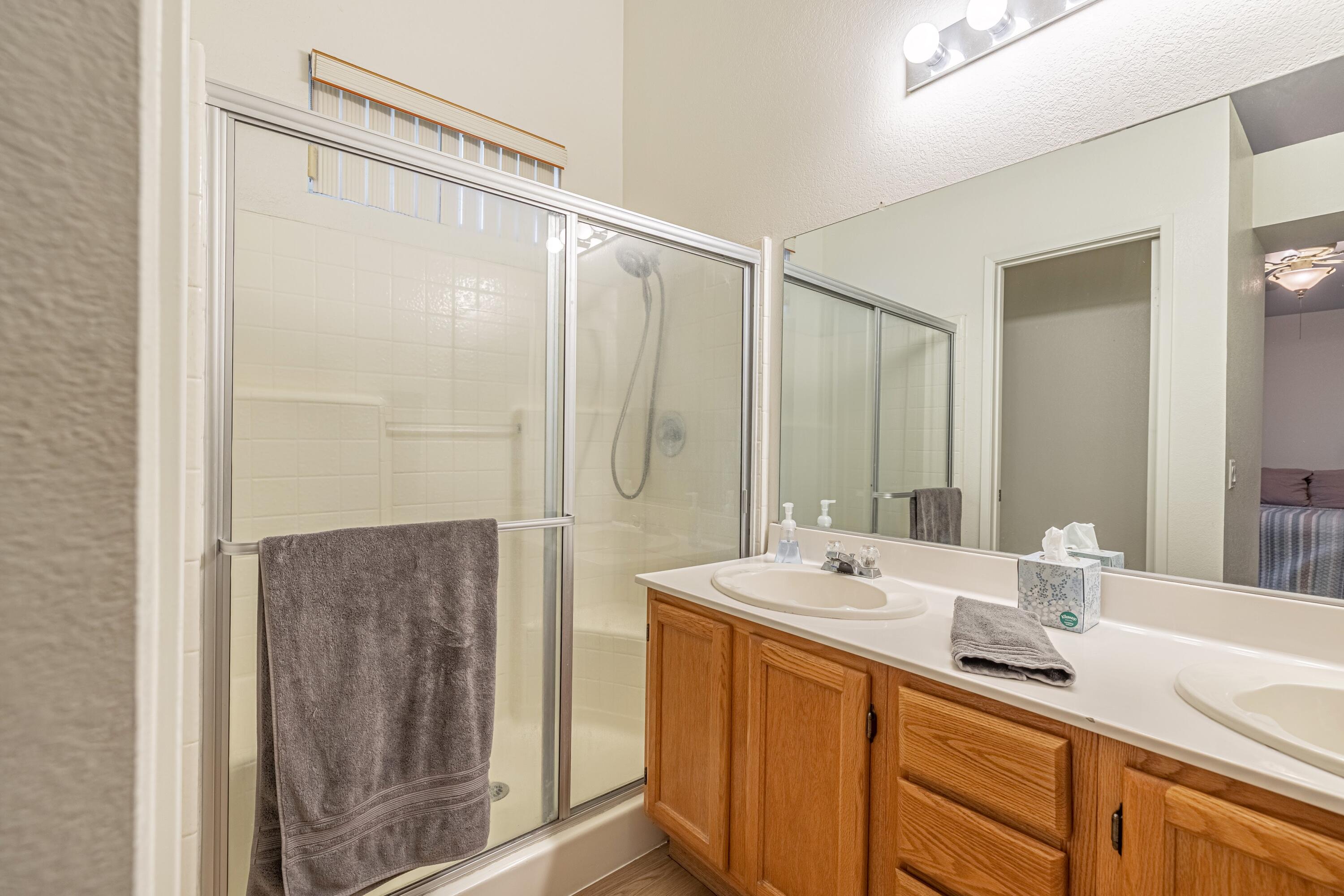 44220 Encanto Way Lancaster, CA 93536 - Photo 21 of 45 a bathroom with a double vanity sink and a mirror