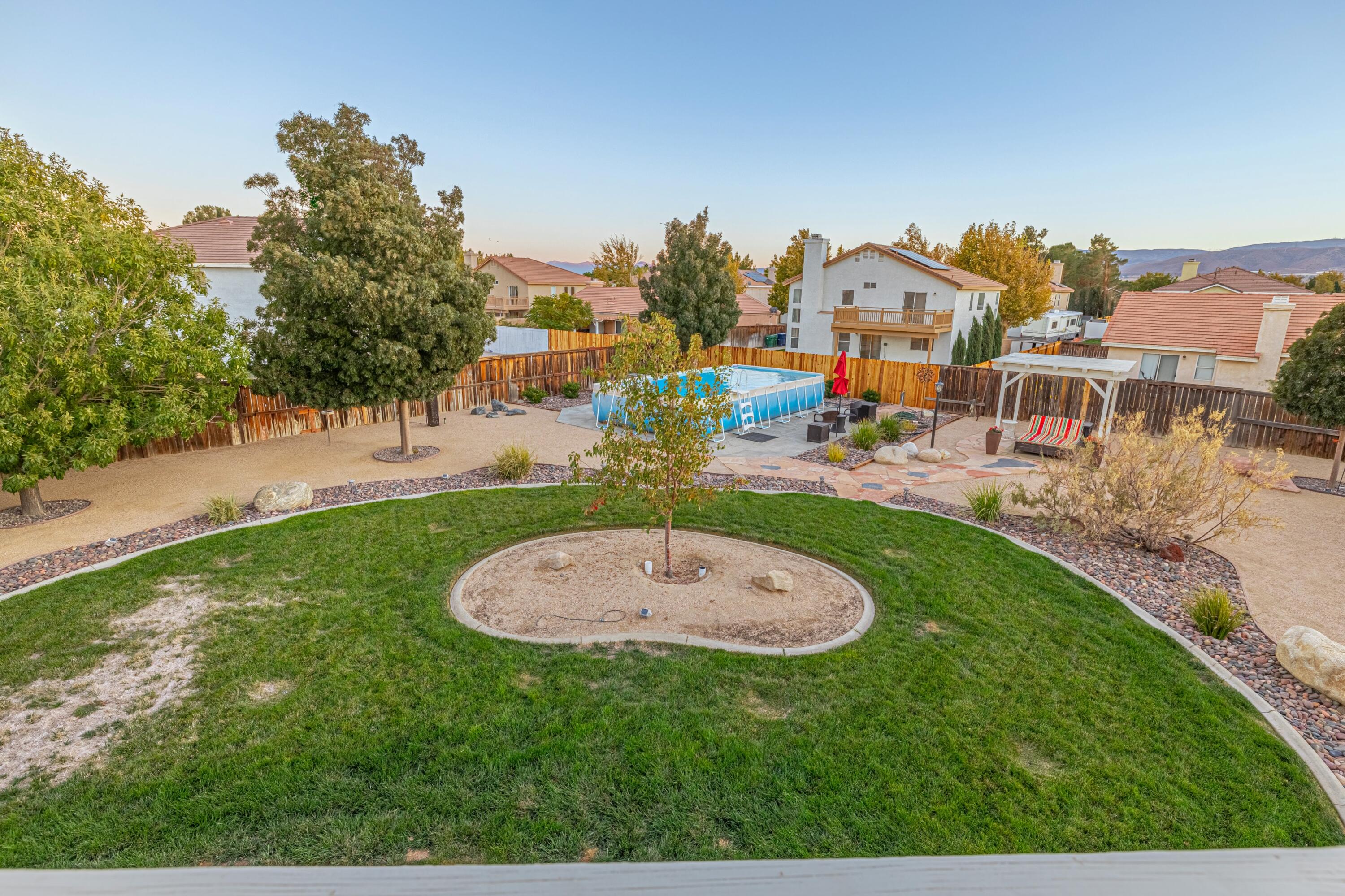 44220 Encanto Way Lancaster, CA 93536 - Photo 24 of 45 an aerial view of a house with outdoor space and trees all around