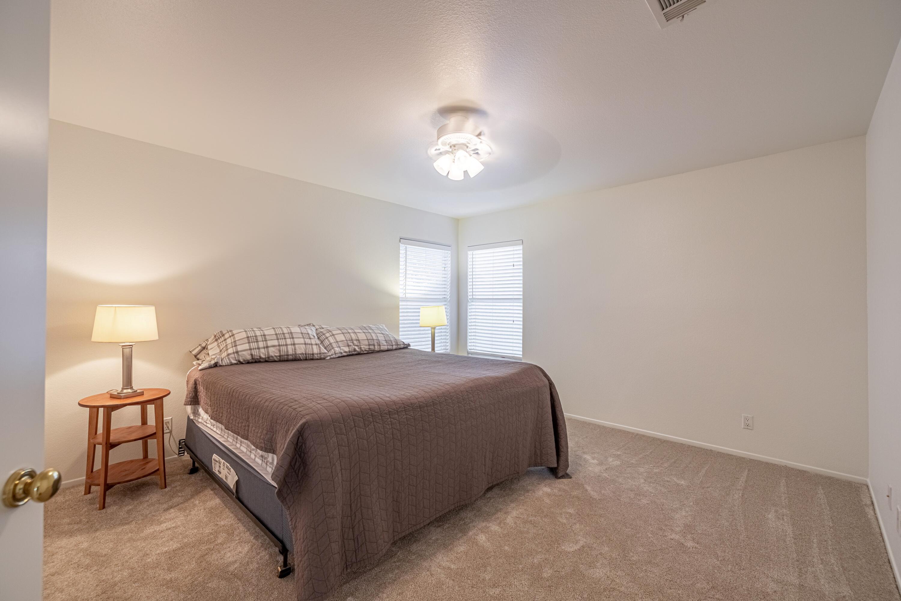 44220 Encanto Way Lancaster, CA 93536 - Photo 25 of 45 a bedroom with a bed and a lamp with window