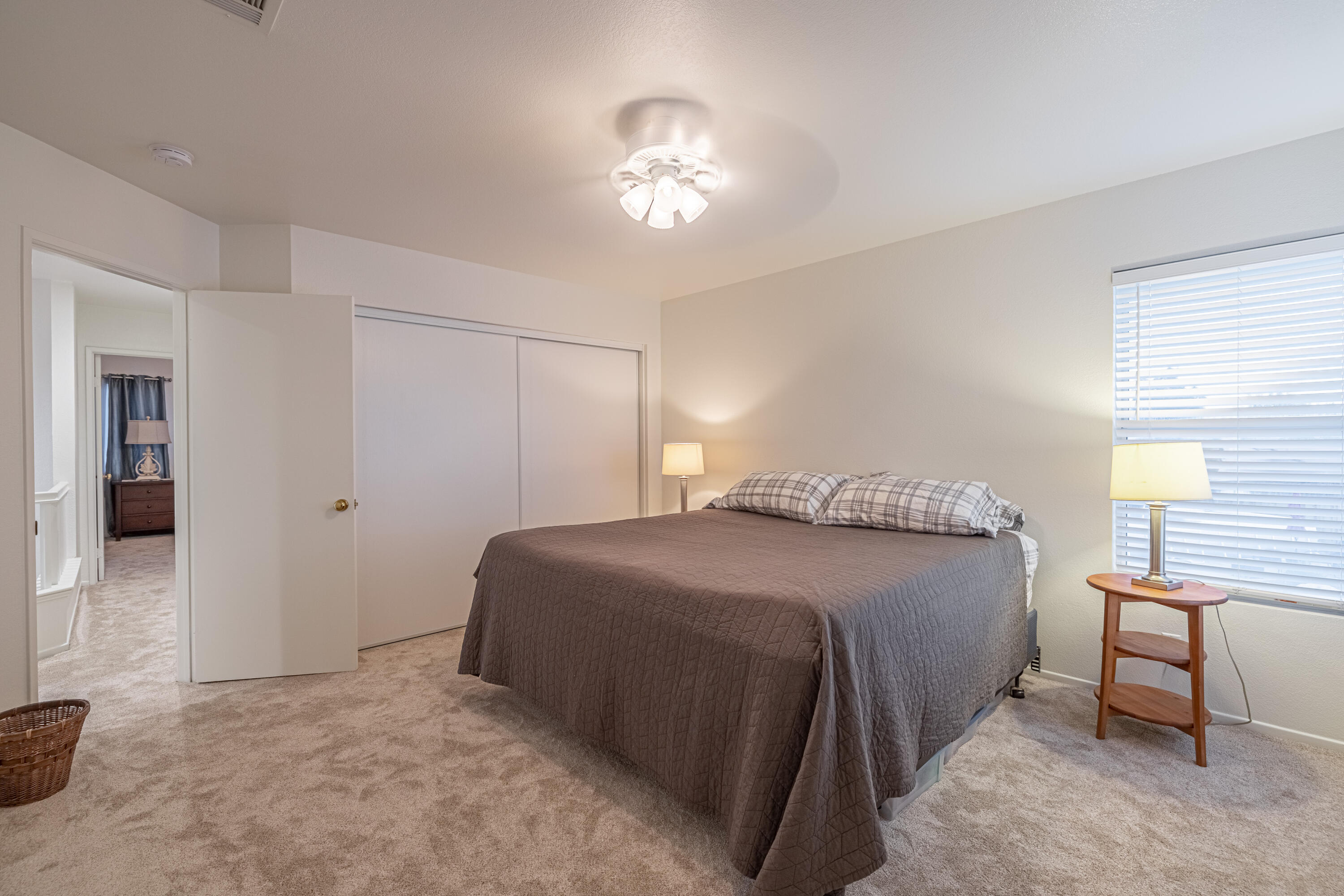 44220 Encanto Way Lancaster, CA 93536 - Photo 26 of 45 a bedroom with a bed and a chandelier