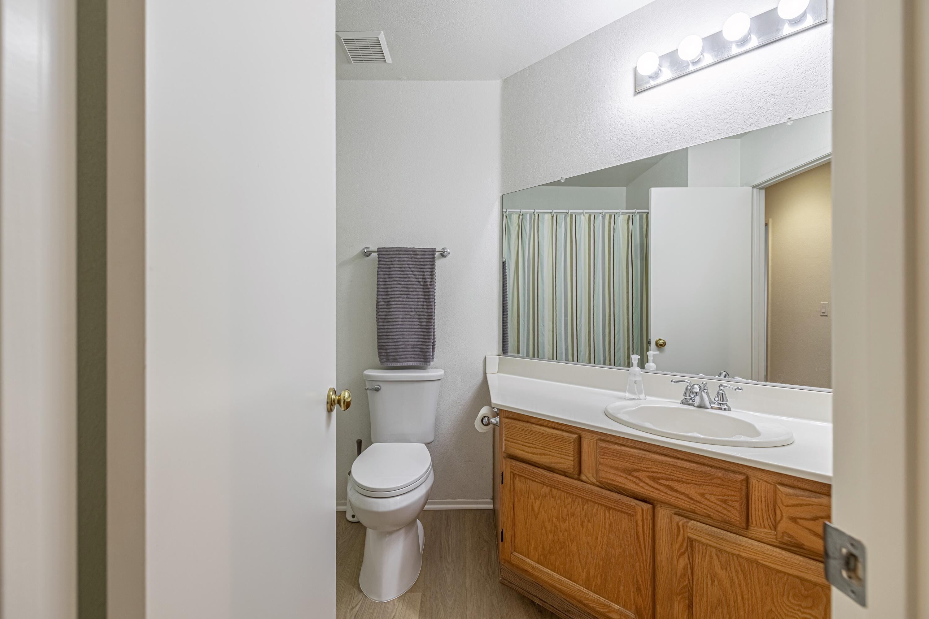 44220 Encanto Way Lancaster, CA 93536 - Photo 29 of 45 a bathroom with a toilet sink and mirror