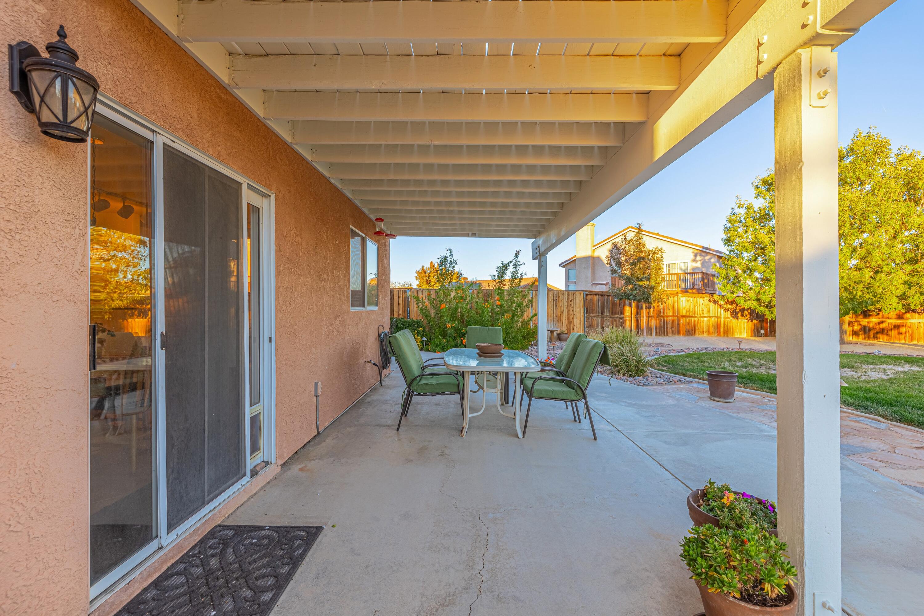 44220 Encanto Way Lancaster, CA 93536 - Photo 36 of 45 a view of a patio with table and chairs and potted plants