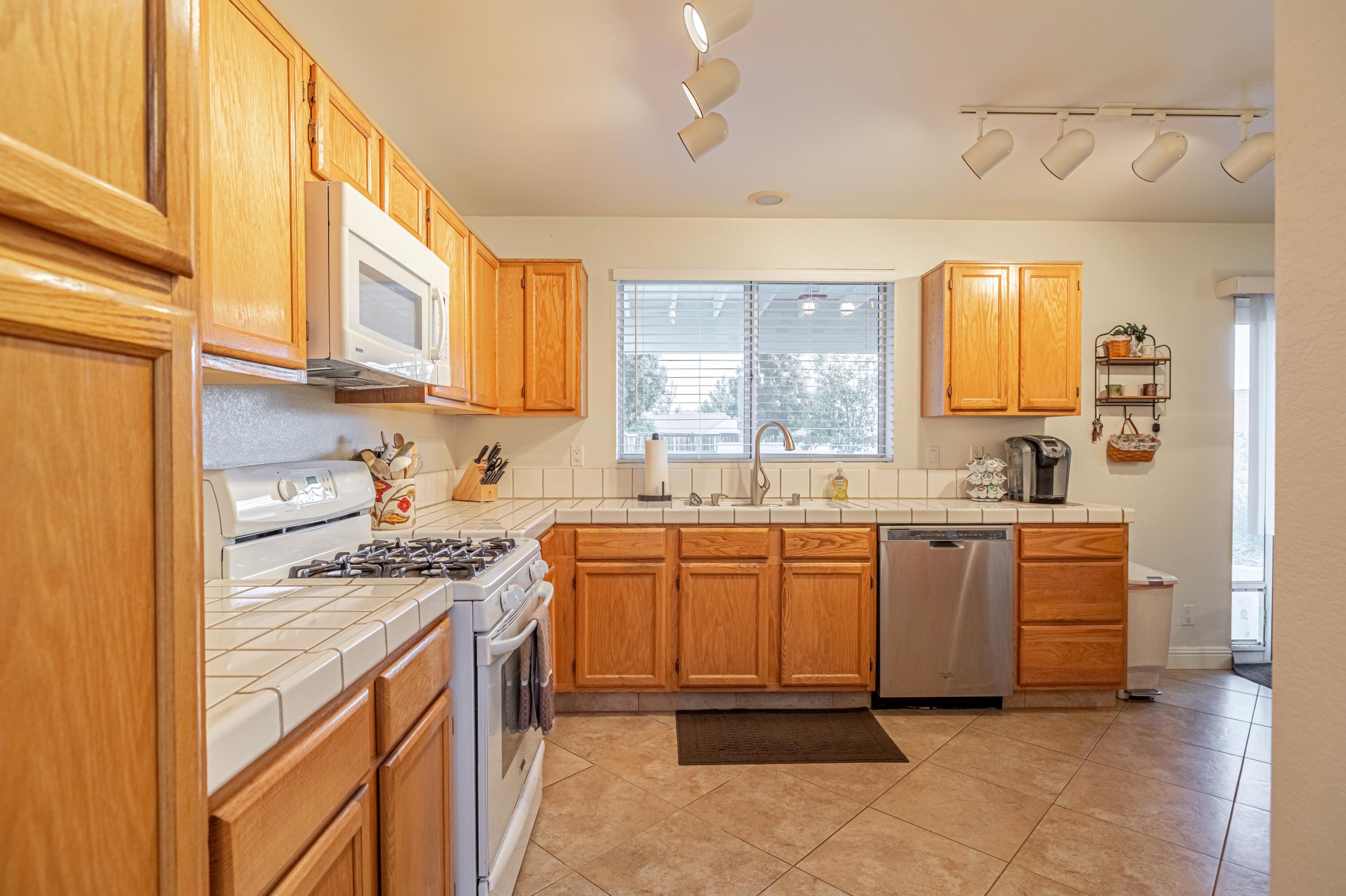 44220 Encanto Way Lancaster, CA 93536 - Photo 8 of 45 a kitchen with stainless steel appliances granite countertop a sink and cabinets