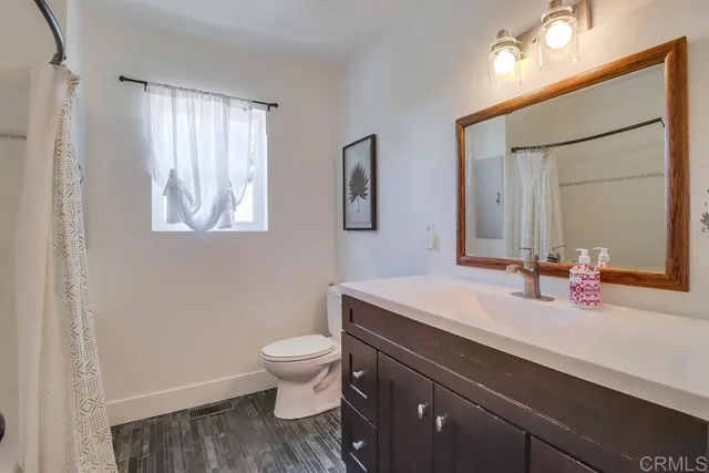 a living room with patio furniture and a floor to ceiling window