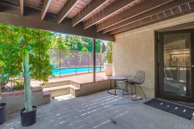 a view of backyard with outdoor seating and green space