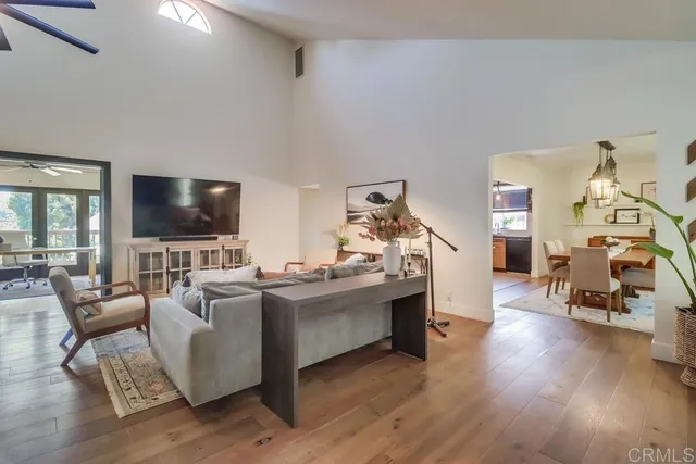 a living room with lots of furniture and kitchen view