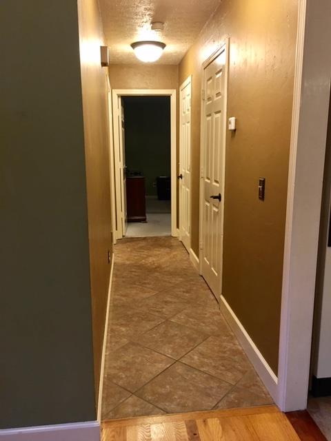 6306 Gum Station Road Springfield, TN 37172 - Photo 18 of 26 Hall on main level has tile flooring and leads to master bedroom and side hall to garage entry.