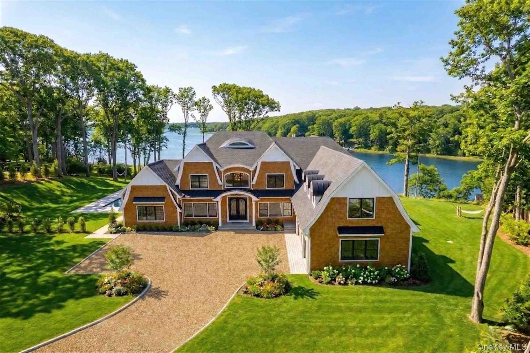 106 Cove Road Asharoken, NY 11768 - Photo 1 of 46 View of front facade with a front lawn and a water view