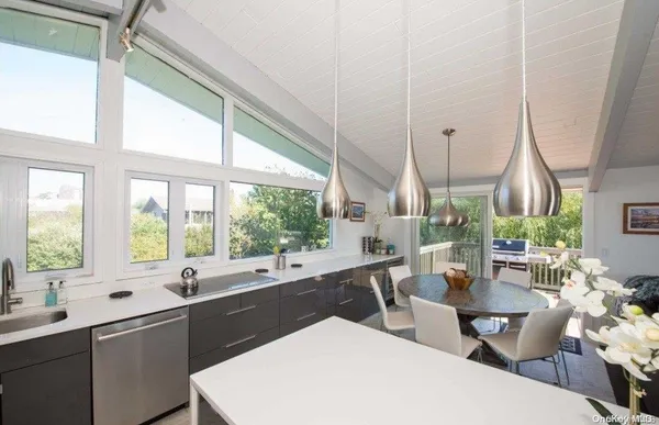 a large kitchen with a large window and cabinets