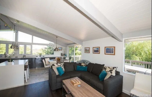 a living room with furniture and large windows