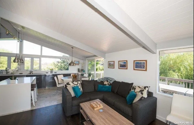 a living room with furniture and large windows