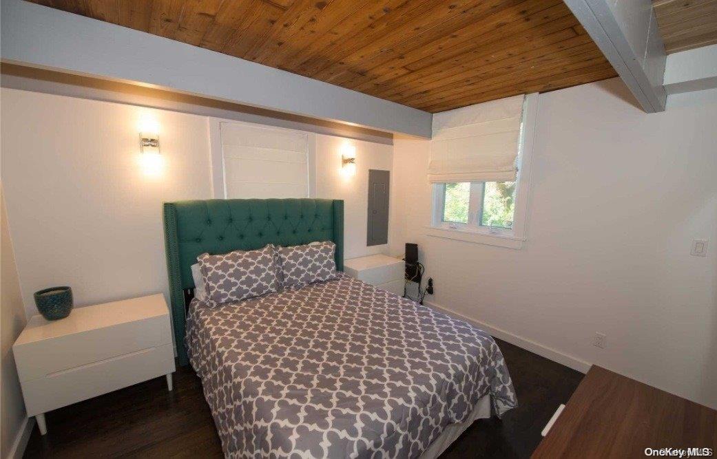 170 Clipper Ocean Beach, NY 11770 - Photo 8 of 11 a bedroom with a bed and a window