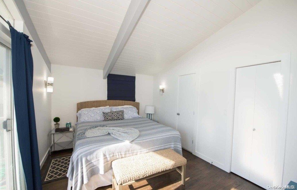 170 Clipper Ocean Beach, NY 11770 - Photo 10 of 11 a bedroom with a bed and a mirror