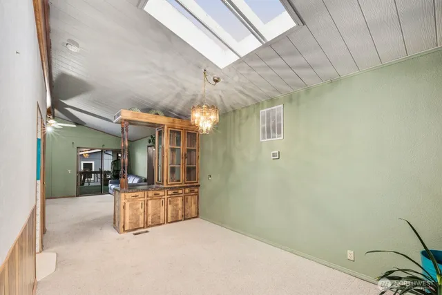 a large kitchen with a large window and stainless steel appliances