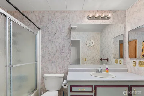 a bathroom with a shower and a sink