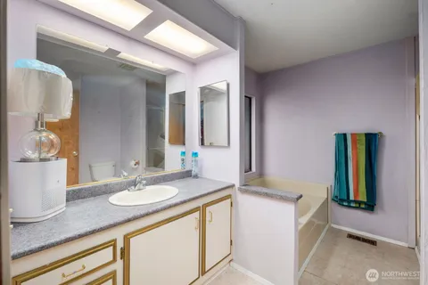 a bathroom with a bathtub and a window