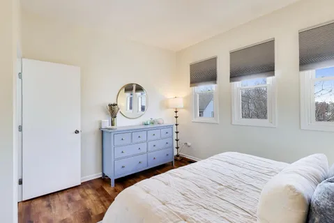 a bedroom with a bed and a dresser