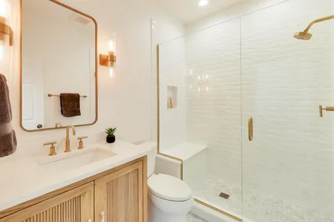 a bathroom with a sink toilet and shower