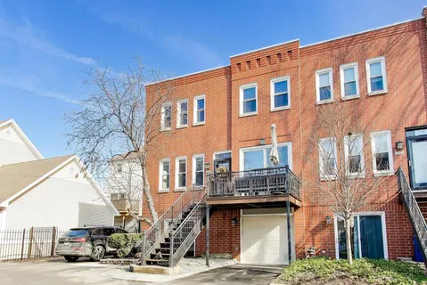 a front view of a residential apartment building with a yard