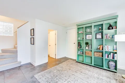 a living room with furniture and a book shelf