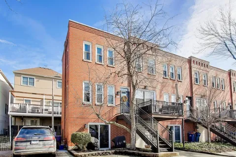 a front view of a building with lot of street