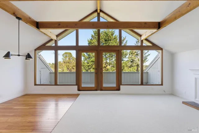 a view of a room with wooden floor