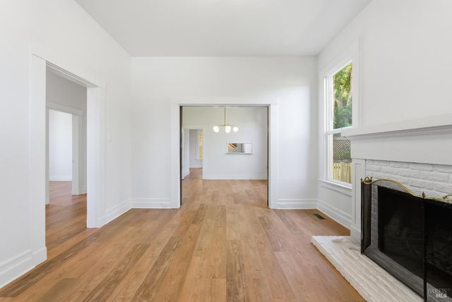 a kitchen with stainless steel appliances granite countertop a sink a stove a refrigerator a window and cabinets